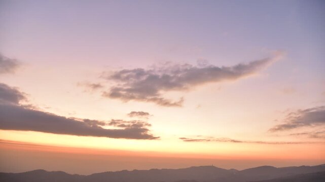 aerial shot sunrise over the mountain behind rain cloudy sky camera moving slow forward to the sun
