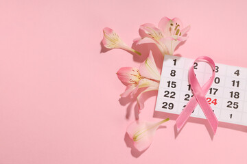 Calendar date marked with a pink ribbon and pink flowers