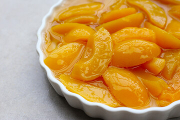Sliced peaches in syrup served in a bowl