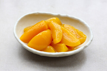 Sliced peaches in syrup served in a bowl