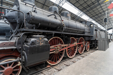 Close-up view of steam locomotive wheels and mechanical drive rods