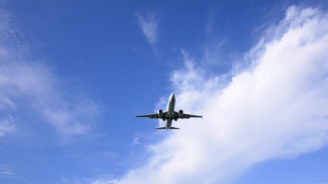 Landing airplane passing over at low altitude 4k video