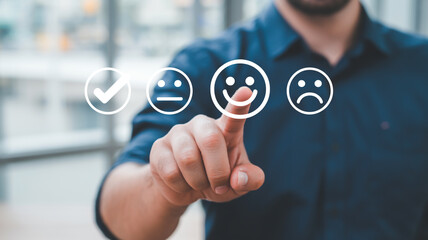 Man selecting happy face on digital interface to provide positive feedback