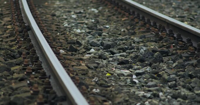 Stone Ballast Covers Sleepers Between Steel Rail Train Tracks Pan Shot
