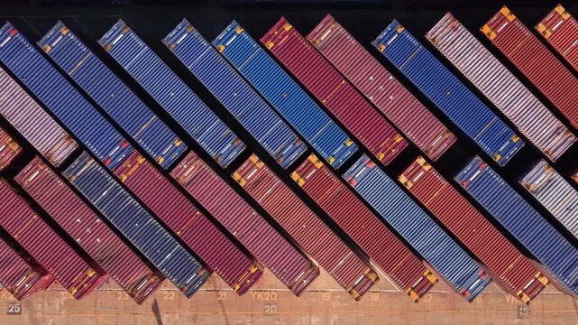 Aerial rising view looking down over rows of shipping containers at Tilbury 2 storage facility Essex