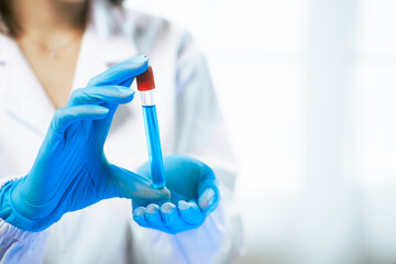 An Asian female scientist carefully analyzes microscopic samples and chemical solutions in a modern laboratory, conducting biology, microbiology, pharmaceutical, and medical research with precision