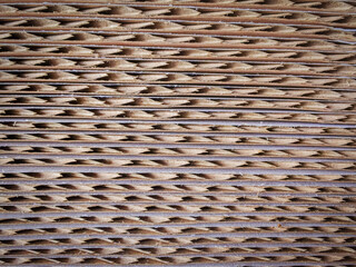 Macro view of stacked corrugated cardboard sheets showing cut edges and fluted texture. Ideal for abstract backgrounds, packaging design, or material studies.