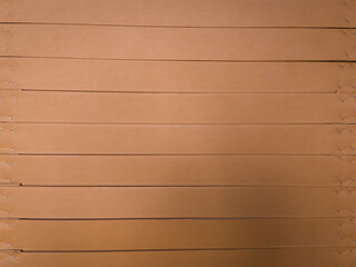 Macro view of layered corrugated cardboard showing cut edges and fluted texture. Ideal for abstract backgrounds, packaging design, or material studies.