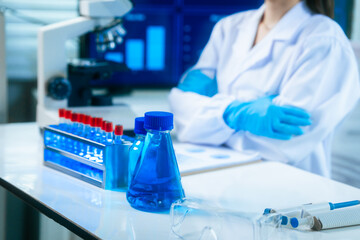 An Asian female scientist in a modern lab interacts with 3D holographic data using VR/MR headset, integrating microscopy, chemical analysis,computational biotechnology immersive, advanced scientific