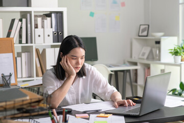 Young Asian Businesswoman looking stressed from work, Young businesswoman working at office feels overworked and burnout