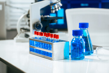 A bright and well-organized laboratory filled with colorful chemical solutions, microscopes, science safety,chemical experiments,safety in a professional biological and chemical research environment