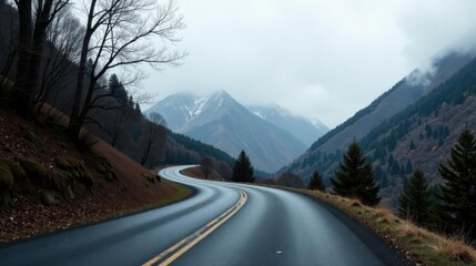Fototapeta premium A Winding Asphalt Road Through a Mountain Valley on an Overcast Day