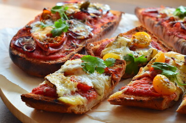 Close-up view of traditional Polish fast food zapiekanka with tomato sauce, melted cheese, and fresh vegetables. The colorful background highlights the vibrant and appetizing street food popular