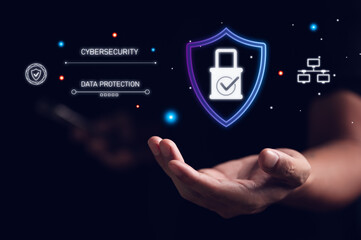 Businessman's hand holding a virtual shield icon with a padlock for cybersecurity and data protection. This concept represents network security, privacy, and a secure technology solution.