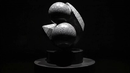 Abstract marble sculpture featuring spherical and faceted shapes mounted on a round pedestal against a dark background - Powered by Adobe