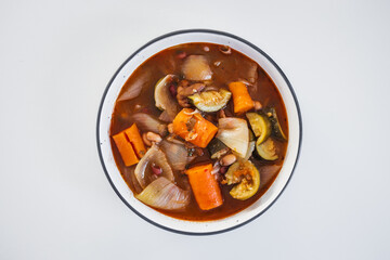bowl of carrot onion and zucchini soup on kitchen counter healthy meal