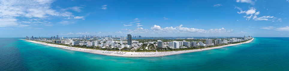 Obraz premium Aerial panorama of Miami Beach coastline. Stunning Miami skyline panorama. Drone panoramic view of Ocean Drive and Art Deco. Downtown Miami waterfront cityscape. South Beach panorama.