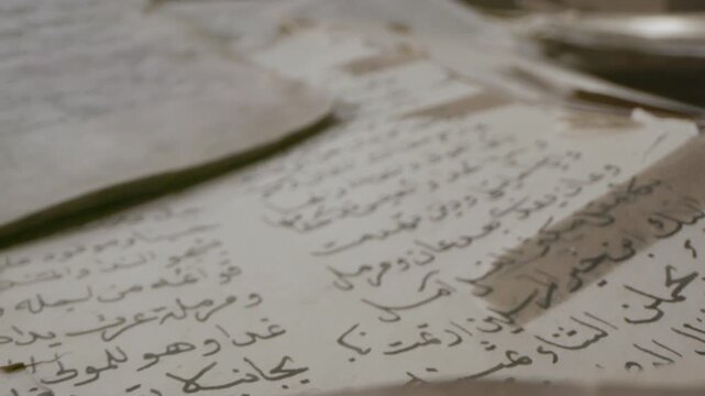 Explore detailed pages of old manuscripts filled with Arabic text in a quiet library. Each sheet reveals history and mystery from the past.