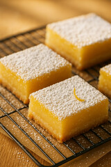 Lemon Bars with Powdered Sugar on Cooling Rack in Warm Light