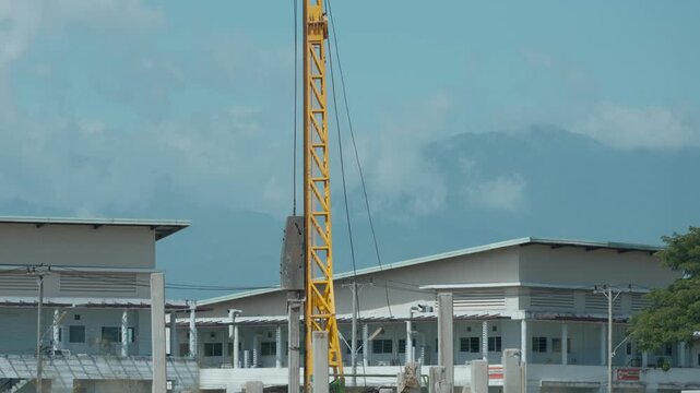 Pile-driving (copra) part of the excavator. Pile driving works at the construction site. Modern hydraulic lifting mechanisms.