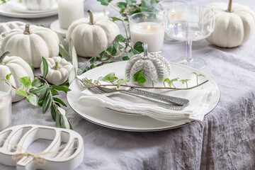 Place settings with white pumpkins for Thanksgiving