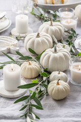 Place settings with white pumpkins for Thanksgiving
