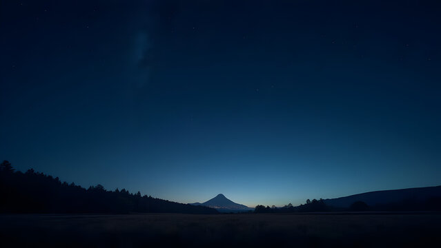 Mystical mountain under a starlit night sky, captured in deep blues and shadows