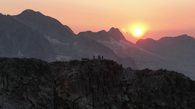 Dos personas en cima de monta&ntilde;a en el pirineo con atardecer de fondo