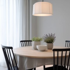 Minimalist Dining Area with Round Light Wood Table, Black Metal Chairs and Geometric Pendant Lamp

