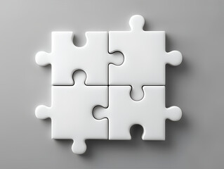 Four white puzzle pieces connected together on soft gray surface