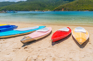 Kayaks on the sandy beach by the sea in the lagoon in summer on vacation