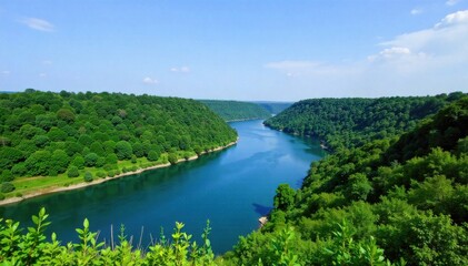 Flowing River Through Lush Landscape A wide, clear river with gentle curves flowing through a lush, vibrant green valley. Rolling hills covered in dense foliage surround the river. The sky is bright