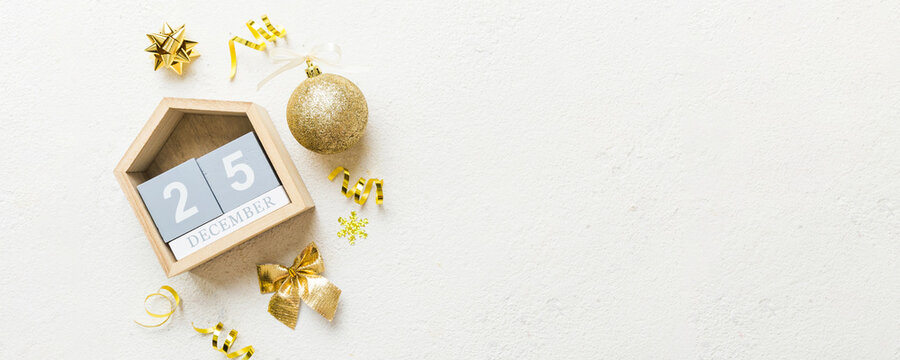 Christmas calendar 25 december. Christmas gift, fir branches, pine cones. Flat lay, top view. New Year decorations on a colored background - Powered by Adobe