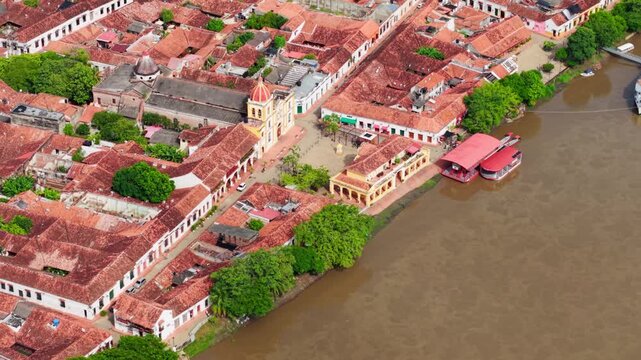 Aerial tilt-down shot of the historic colonial town of Mompox on the banks of the muddy Magdalena River