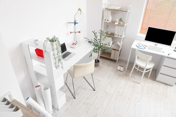 Interior of medical office with desks and shelf units