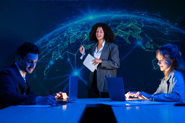 Diverse business team in a meeting, with a female leader presenting a global strategy on a large screen.