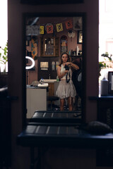 Portrait of a woman holding a camera in a tattoo studio