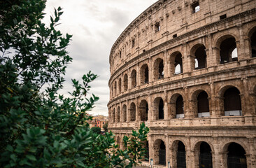 Fototapeta premium Ancient Roman Colosseum with arches and stone architecture in Rome