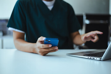 Professional doctor using digital tablet and laptop on desk. Healthcare technology.Modern business work and care service
