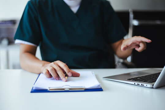 Professional healthcare worker calculating finance and budget data on a calculator. Medical accounting for cost analysis and insurance planning.