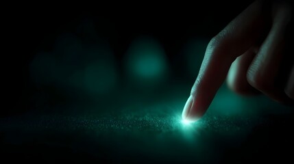 A fingertip touches a bright glowing teal light source on a dark textured surface symbolizing interaction and discovery
