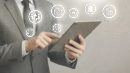 A male businessman manages a real estate business administration system with modern digital innovation technology.