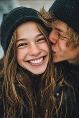 Teenage girlfriend and boyfriend have fun outdoors, kissing and hugging, first