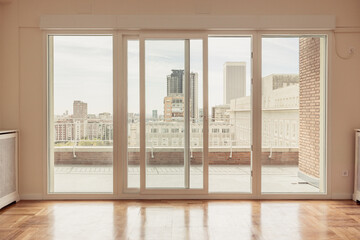 Fototapeta premium Empty apartment with terrace with views of Madrid skyline