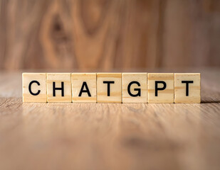 Wooden blocks spelling the word &ldquo;ChatGPT&rdquo; on a wooden desk, representing modern business innovation, digital transformation, and AI-driven communication in the workplace.
