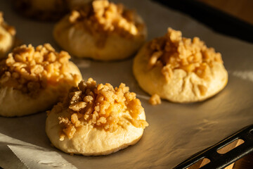 Unbaked homemade traditional Czech Moravian buns (kolače) with cottage cheese , apple and crumbs on before baking.