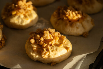 Unbaked homemade traditional Czech Moravian buns (kolače) with cottage cheese , apple and crumbs on before baking.