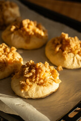 Unbaked homemade traditional Czech Moravian buns (kolače) with cottage cheese , apple and crumbs on before baking.