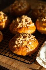 Freshly baked homemade traditional Czech Moravian buns (kolače) with cottage cheese , apple and crumbs on cooling rake.