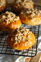 Freshly baked homemade traditional Czech Moravian buns (kolače) with cottage cheese , apple and crumbs on cooling rake.